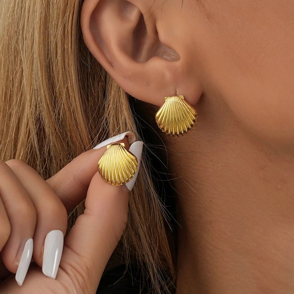 Close-up of a woman wearing Vintage Shell Design Stud Earrings for Women, showcasing new fashion with a focus on her ear and the hand adjusting the earring.