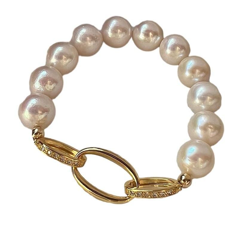 Chic Crystal & Pearl Hand Catenary Fashion Mood Tracker Bracelet reflecting new fashion trends with a gold clasp, isolated on a white background.