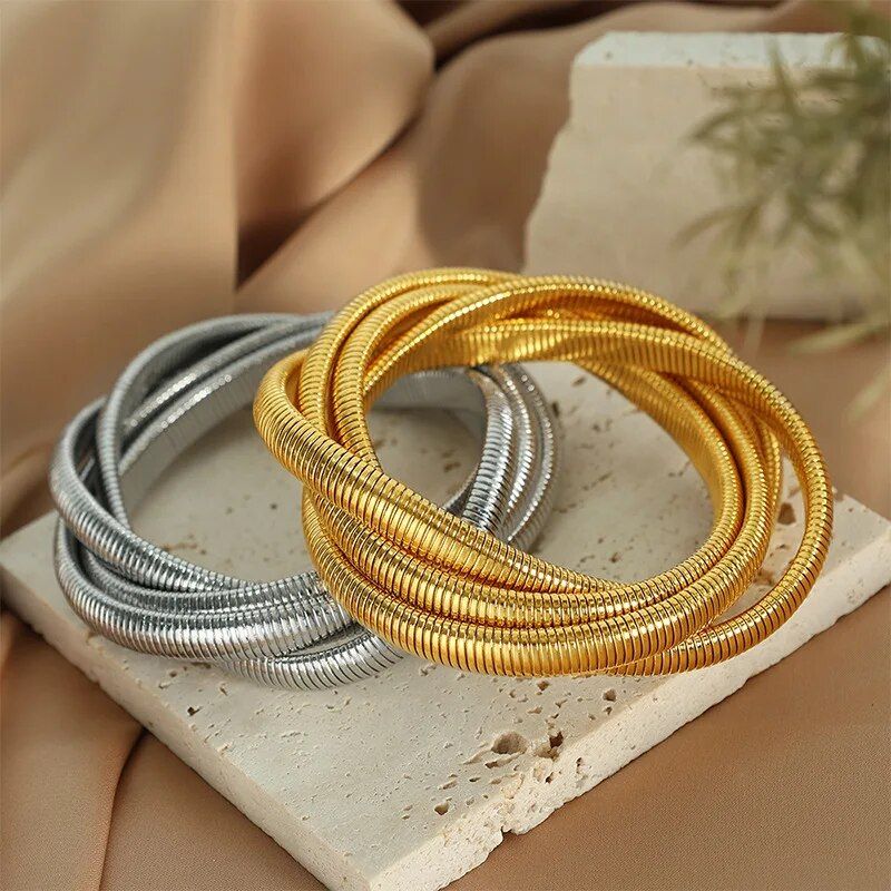 Trendy Punk Style Gold-Plated Geometric Womens Bangles, a new fashion accessory, on a beige fabric background.