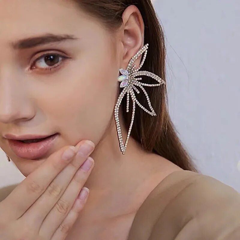 Close-up of a woman wearing a large, decorative Chic Maple Leaf Zircon Earring, showcasing new fashion trends.