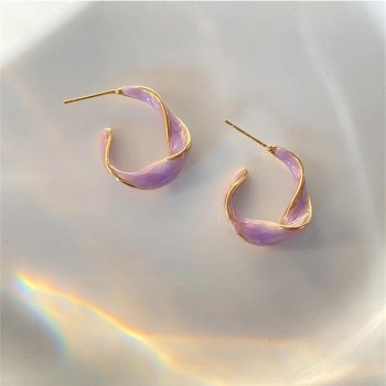 Pair of Lavender Purple Twisted Hoop Earrings on a white dish with a rainbow reflection, embodying contemporary womens fashion.