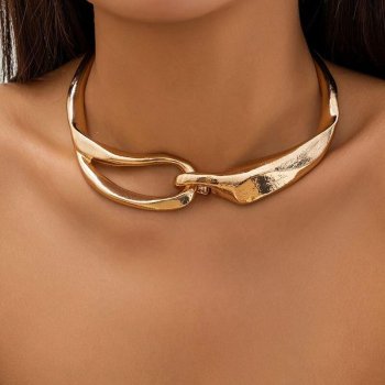 Close-up of a woman wearing a Chunky Metal Buckle Gold Choker Necklace with a unique clasp design, showcasing current fashion trends on her neck.