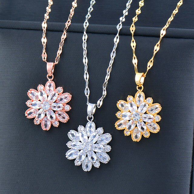 Four Womens Gold-Plated Crystal Flower Pendant Chokers with gemstones on black background, showcasing new fashion trends and varying in color from silver, gold, rose gold, to a mix of pink and white.