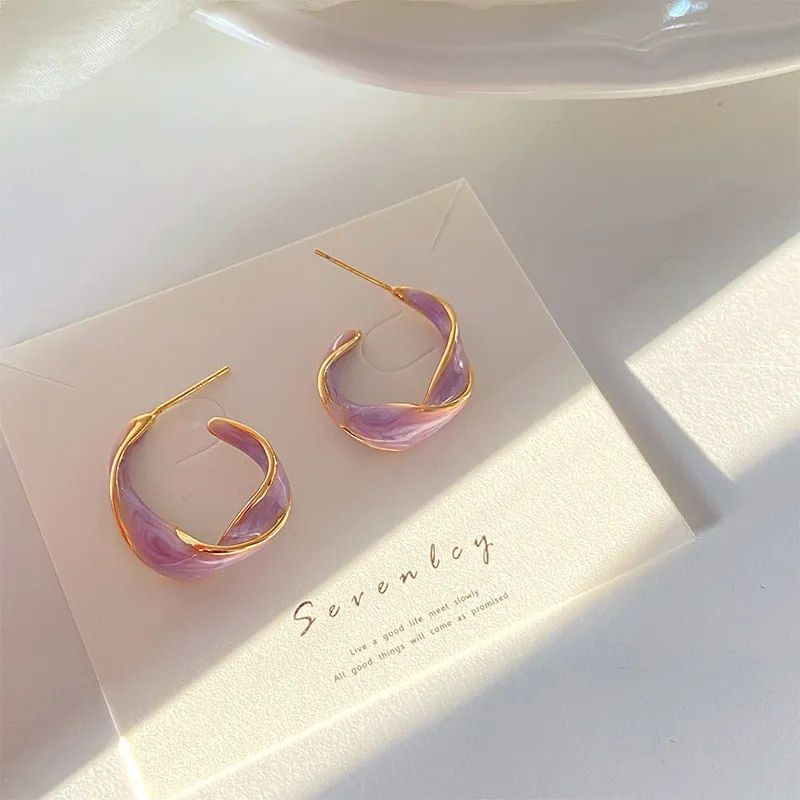 Lavender Purple Twisted Hoop Earrings, a trendy women's fashion accessory, displayed on a cream card under soft lighting.