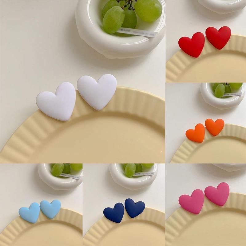 A collage of images displaying pairs of Colorful Heart-Shaped Acrylic Earrings for Women in various colors arranged on a plate, showcasing new fashion aesthetics, with some featuring a bowl of grapes in the background.