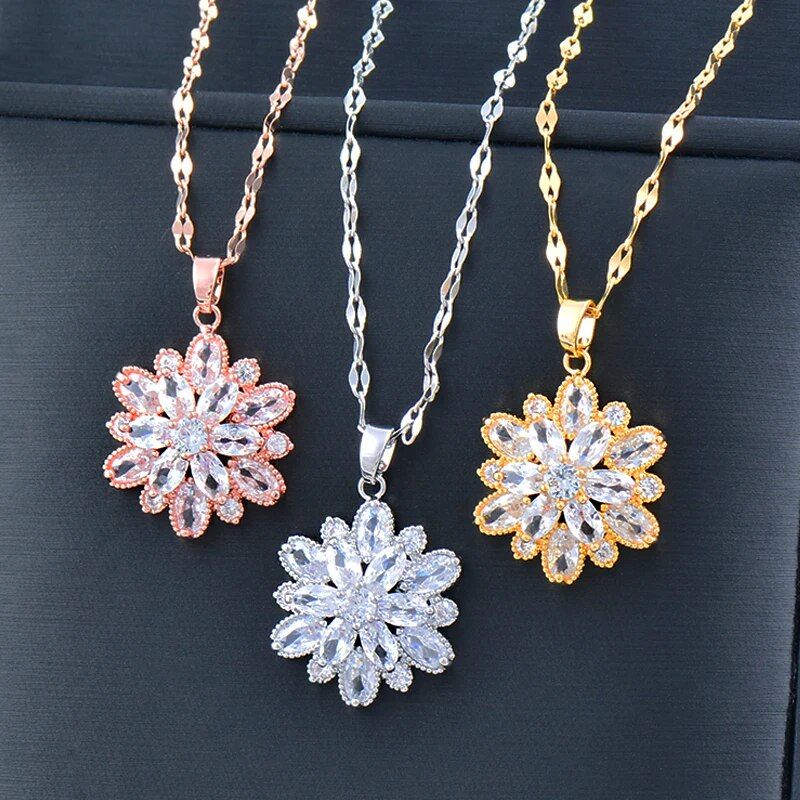 Four Womens Gold-Plated Crystal Flower Pendant Choker necklaces showcased on a black background, aligning with new fashion trends.