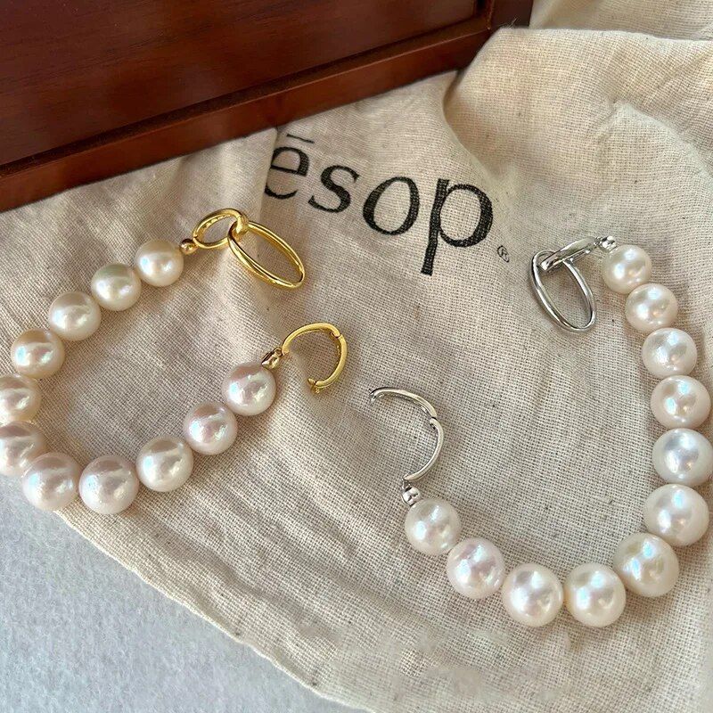 Chic Crystal & Pearl Hand Catenary Fashion Mood Tracker Bracelet displayed on a beige fabric surface with "esop" text partially visible, reflecting the latest fashion trends.