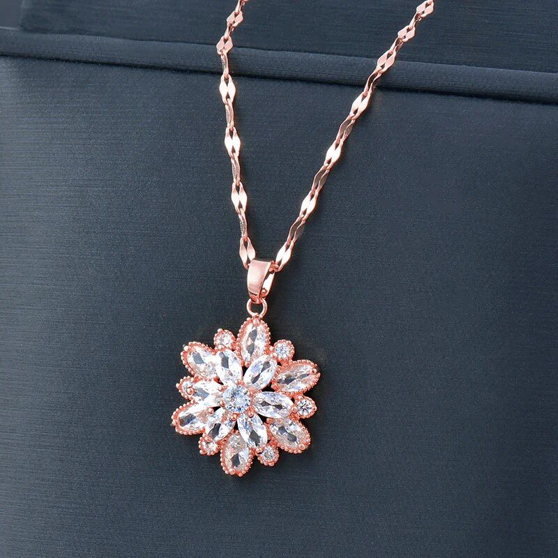 A women's gold-plated crystal flower pendant choker adorned with pink and clear crystals, displayed against a black background. This piece is the latest in new fashion style.