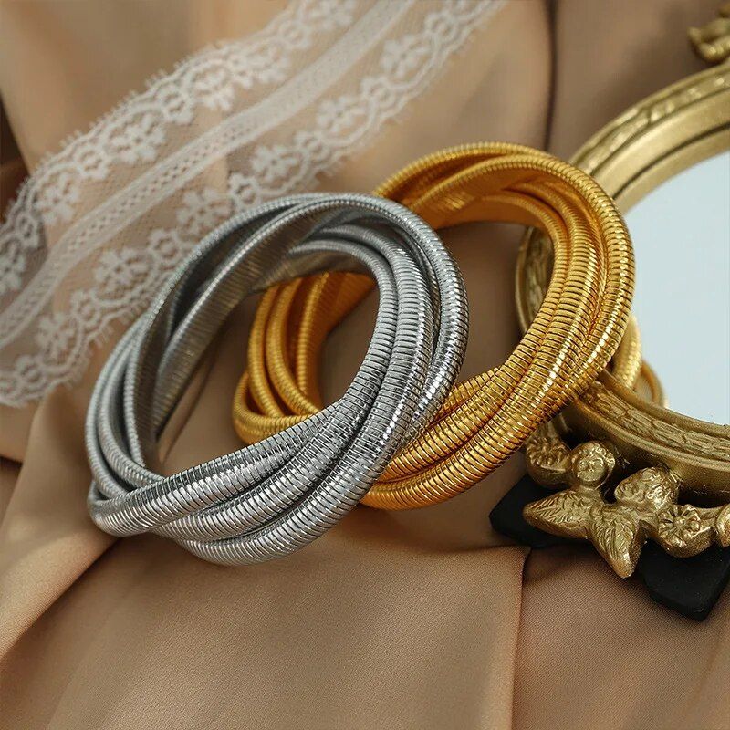 Trendy Punk Style Gold-Plated Geometric Womens Bangle, a chic new fashion accessory, displayed on draped beige fabric with lace and a black ornate buckle detail.